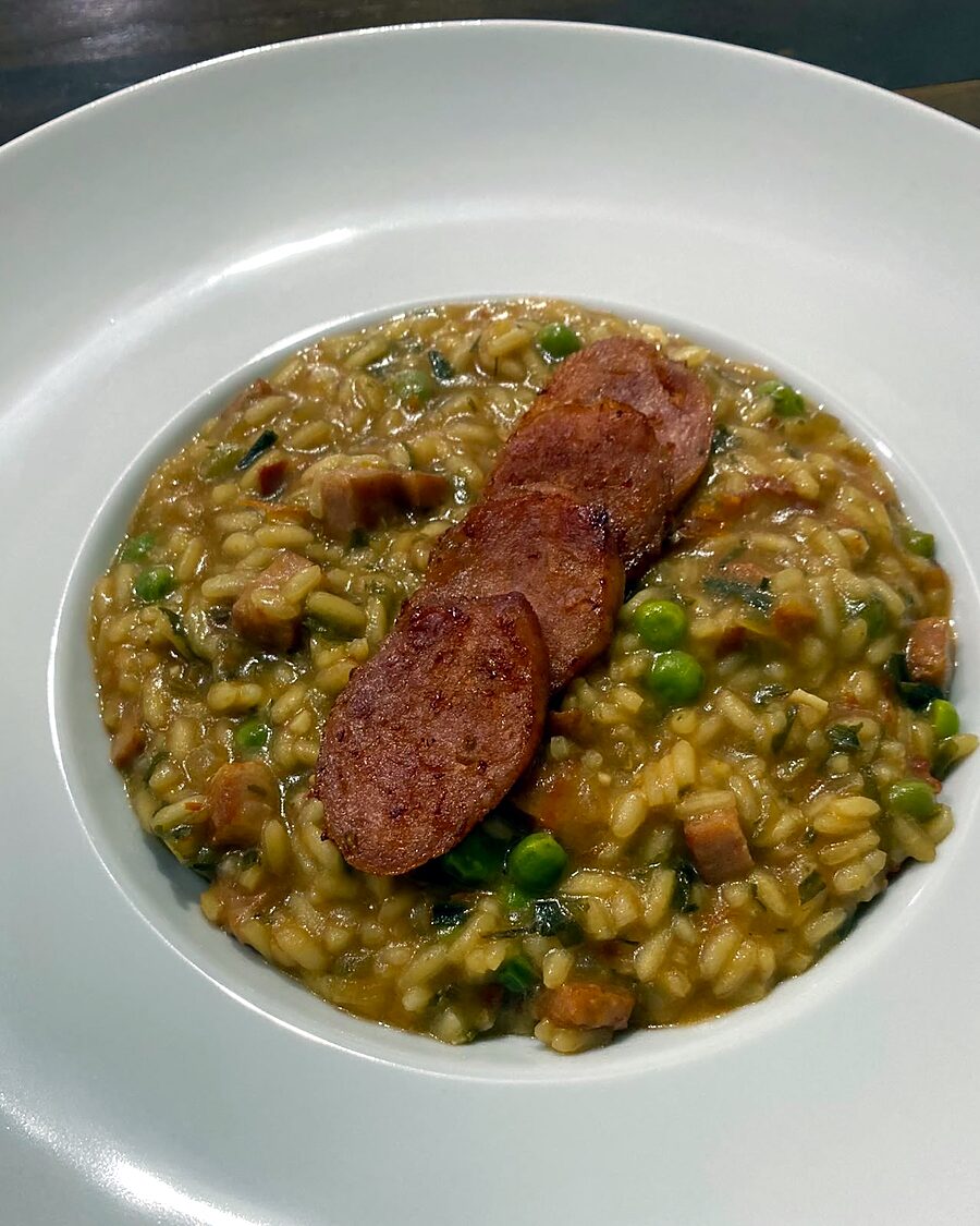 Risoto de linguiça calabresa com rodelas douradas e ervilhas